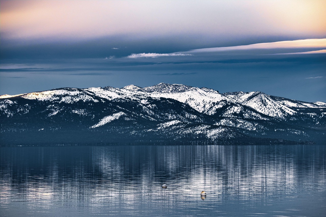 Lake Tahoe winter landscape with snowy mountains and pine trees