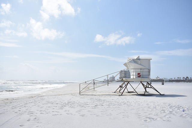 People relaxing on a sunny day at South Beach with iconic lifeguard stands