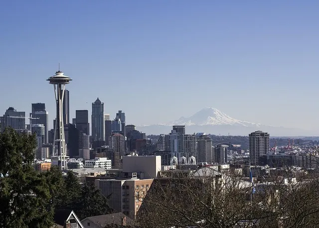 A panoramic view of Seattle's Space Needle and downtown skyline with Mount Rainier in the background